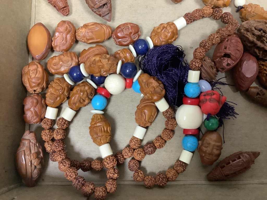 A quantity of Chinese peach stone and nut carvings
